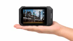 Compact SonoCam Pocket acoustic imaging camera displayed in a hand, featuring a lightweight design for portable leak detection, sound source localization, and predictive maintenance inspections.